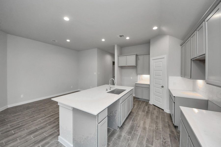 The open concept effortlessly connects the kitchen to the expansive family room, forming a perfect hub for gatherings. This seamless flow creates an inviting space where cooking and socializing come together harmoniously. Sample photo of completed home with similar floor plan. Actual colors and selections may vary. The open concept effortlessly connects the kitchen to the expansive family room, forming a perfect hub for gatherings. This seamless flow creates an inviting space where cooking and socializing come together harmoniously. Sample photo of completed home with similar floor plan. Actual colors and selections may vary.