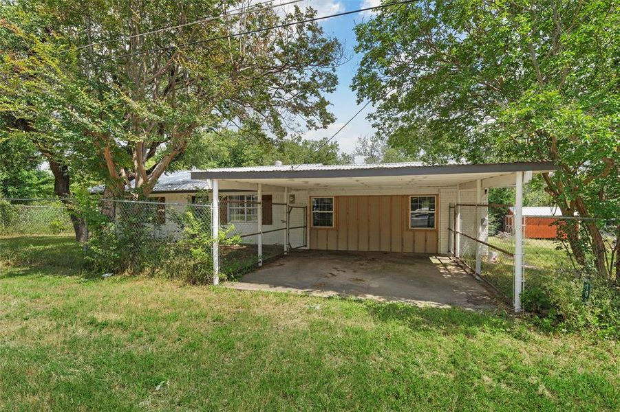 Rear view of house with an attached carport and metal roof Rear view of house with an attached carport and metal roof