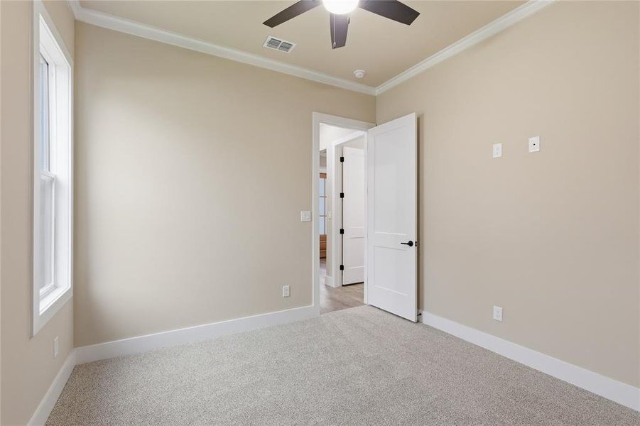 Neutral-toned room with light gray carpeting and white trim Neutral-toned room with light gray carpeting and white trim