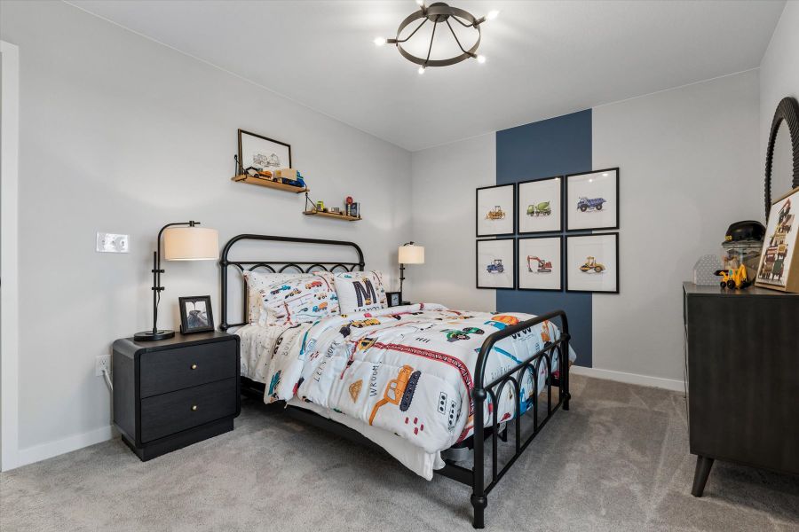 A bedroom with a bed and dresser. A bedroom with a bed and dresser.