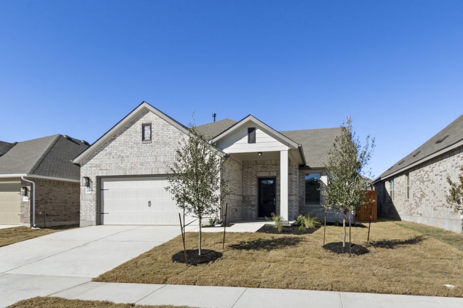 Front exterior of a new home in Crosswinds, Kyle, TX, highlighting curb appeal (Image 1). Front exterior of a new home in Crosswinds, Kyle, TX, highlighting curb appeal (Image 1).
