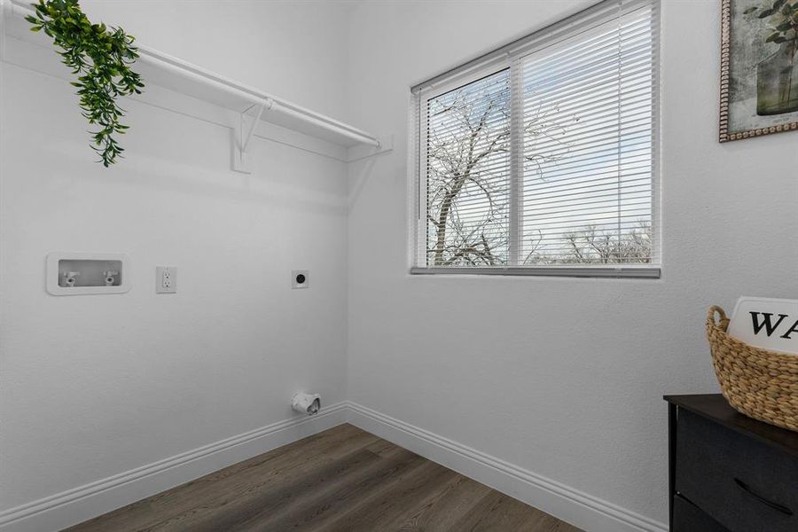 Laundry room with hookup for a washing machine, electric dryer hookup, and dark hardwood / wood-style floors