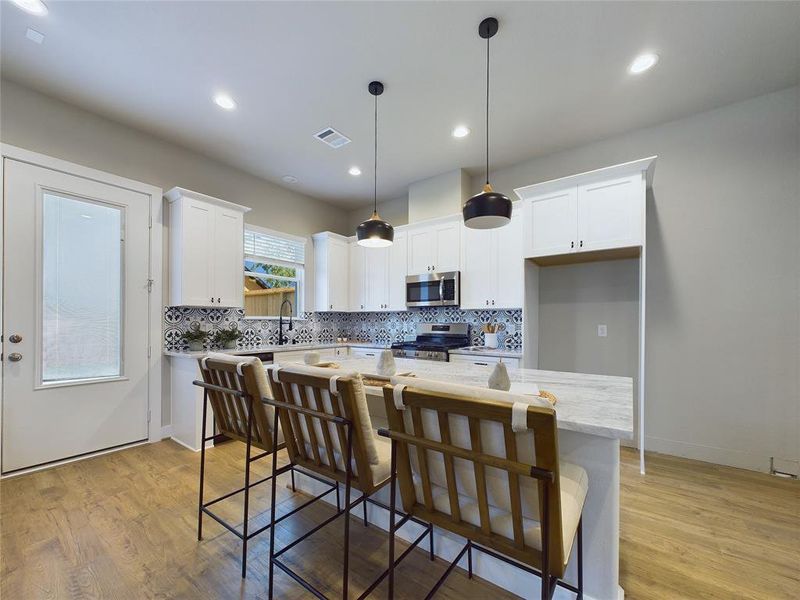 The kitchen has beautiful features with stainless steel appliances and