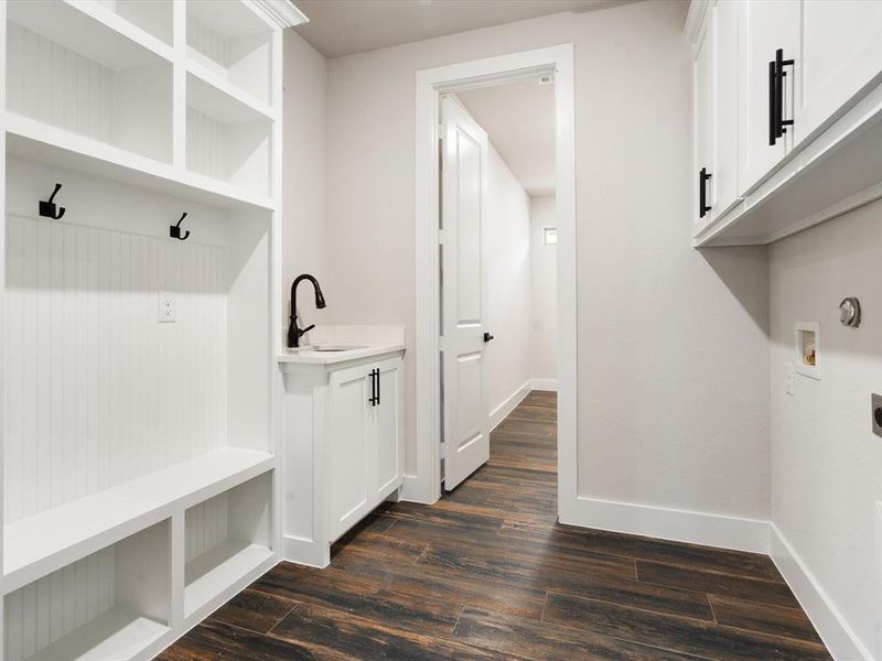 Mudroom with dark hardwood / wood-style floors and sink