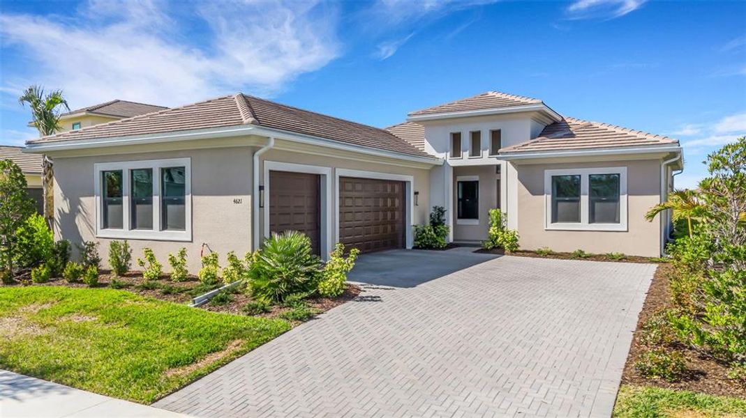 Front exterior of a new home in Artistry Sarasota, Sarasota, FL, highlighting curb appeal (Image 23).