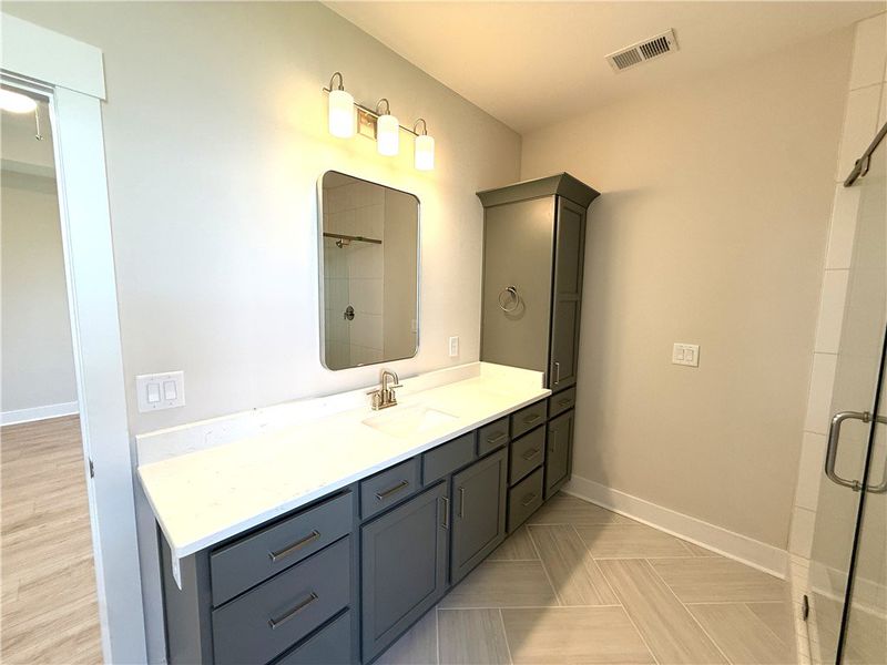 This primary bathroom features a double vanity and