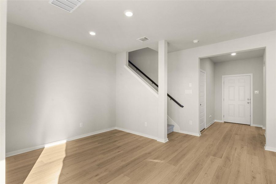 Unfurnished living room with recessed lighting and light wood-type flooring