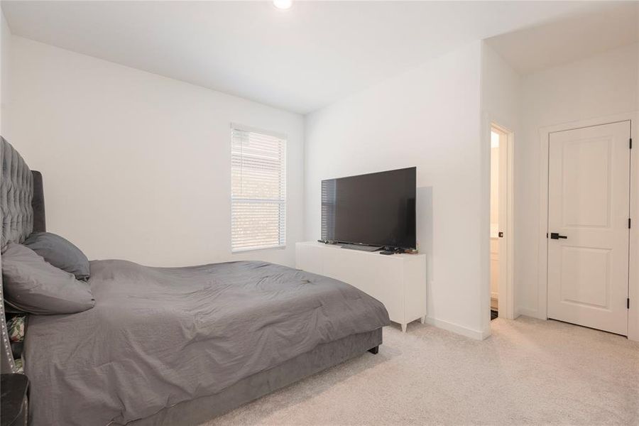Bedroom featuring carpet flooring and baseboards Bedroom featuring carpet flooring and baseboards