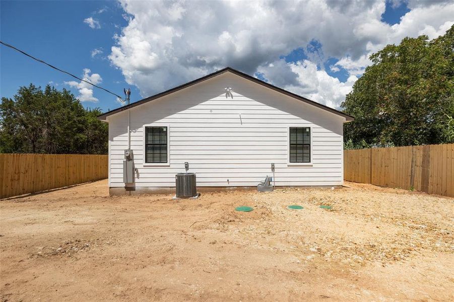 View of side of property with central air condition unit