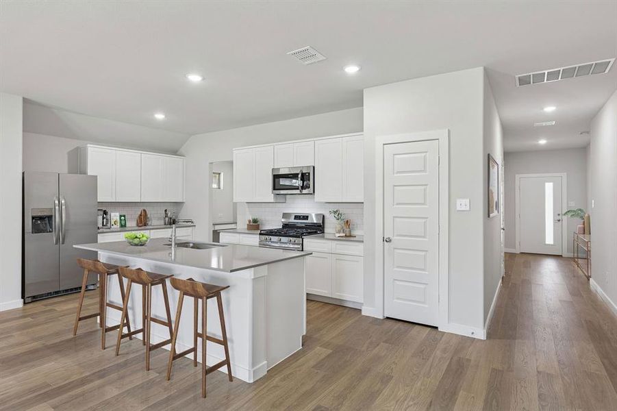 Kitchen in the Harrison home plan by Trophy Signature Homes – REPRESENTATIVE PHOTO