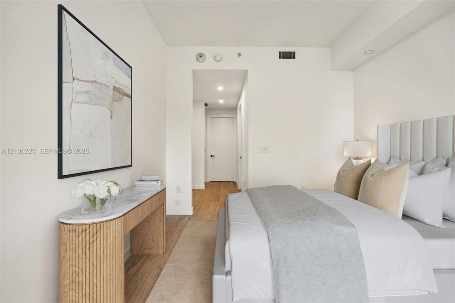 Neutral interior featuring recessed lighting, wood-finish flooring, and a smooth ceiling finish Neutral interior featuring recessed lighting, wood-finish flooring, and a smooth ceiling finish