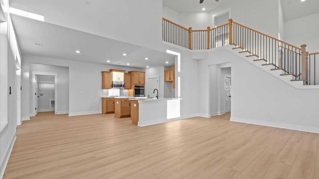 Exceptional family space featuring two-story ceilings, hardwood flooring, and tasteful finishes throughout