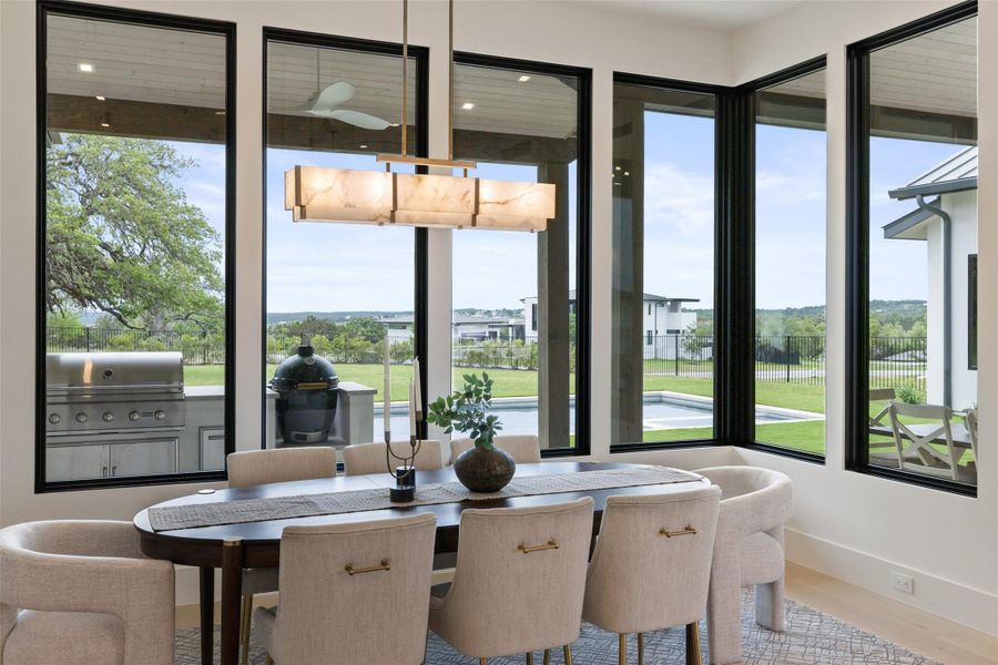 Dining room featuring baseboards, wood finished floors, and plenty of natural light Dining room featuring baseboards, wood finished floors, and plenty of natural light
