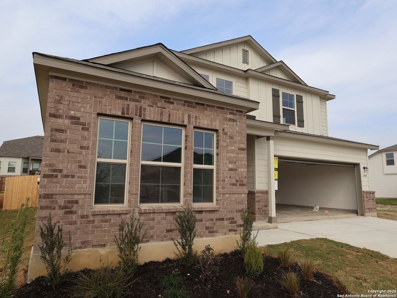 Front exterior of a new home in Greenspoint Heights, Seguin, TX, highlighting curb appeal (Image 22).