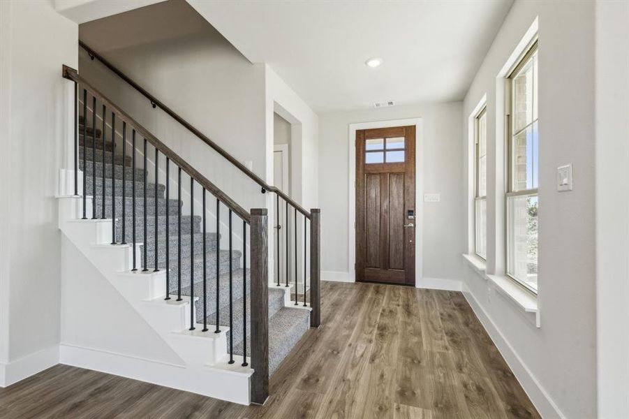 Entryway featuring wood-type flooring and a healthy amount of sunlight