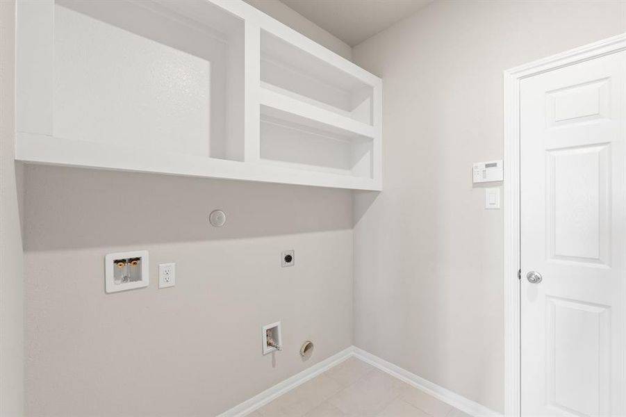 The laundry room layout is carefully planned for optimal workflow with designated areas for washing, drying, and storing.