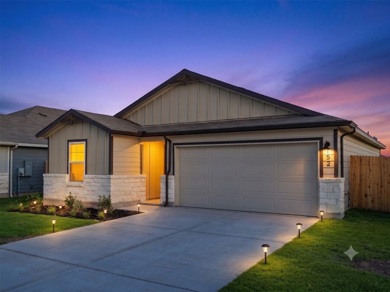Board and batten siding pairs beautifully with stone accents under a dramatic twilight sky.