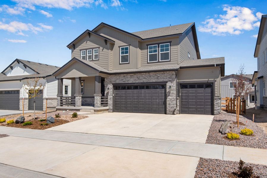 Front exterior of a new home in The Aurora Highlands, Aurora, CO, highlighting curb appeal (Image 24).