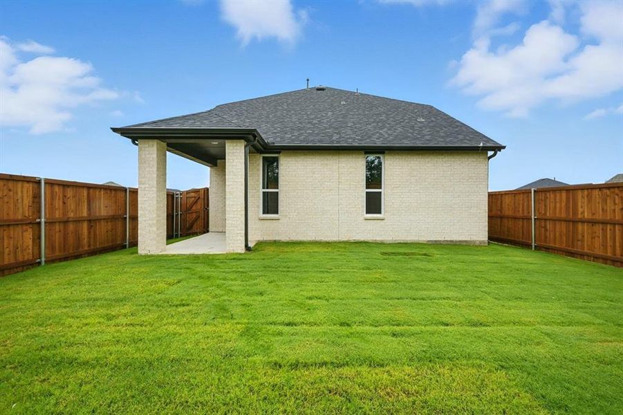Back of house featuring a patio area, roof with shingles, brick siding, and a fenced backyard Back of house featuring a patio area, roof with shingles, brick siding, and a fenced backyard
