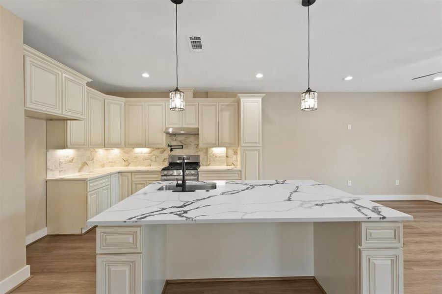 The kitchen features stunning quartz countertops that gleam under the light, offering a sleek and durable surface perfect for both cooking and entertaining.