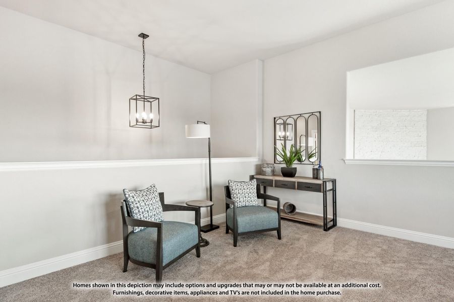 Sitting room with two blue accent chairs, pendant light, console table, and carpet flooring Sitting room with two blue accent chairs, pendant light, console table, and carpet flooring