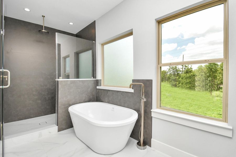 Here is another view of the primary ensuite bathroom which highlights the fabulous windows, the relaxing soaking tub and the spacious walk-in shower with a rainfall shower ahead above! Here is another view of the primary ensuite bathroom which highlights the fabulous windows, the relaxing soaking tub and the spacious walk-in shower with a rainfall shower ahead above!
