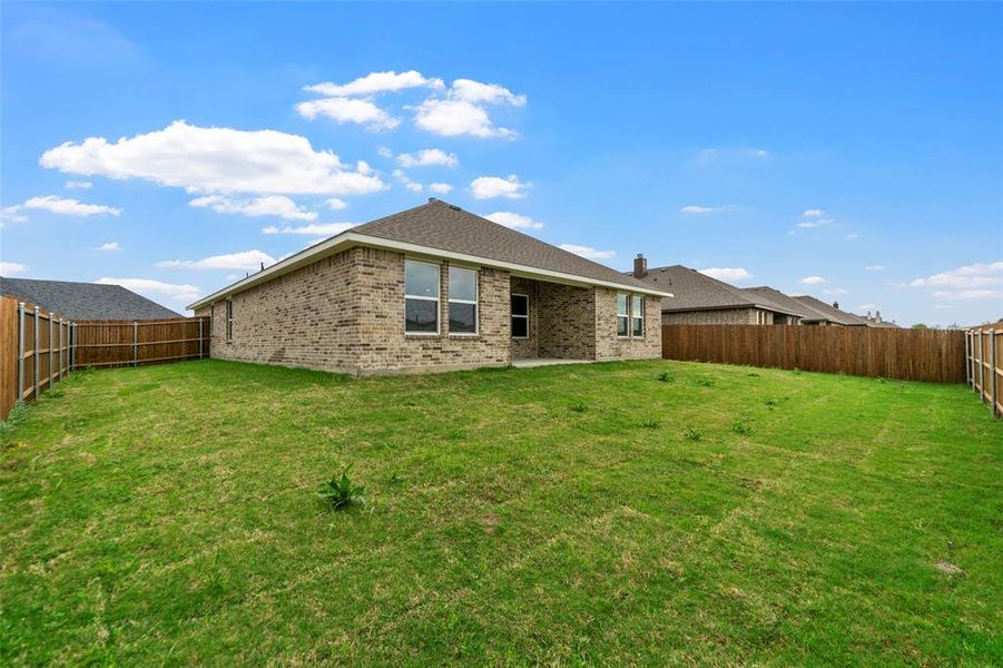 Spacious rear yard with a perimeter wood privacy fence