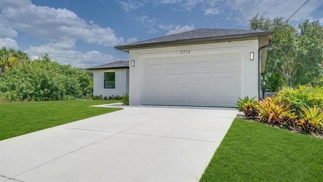 Front exterior of a new home in , Lehigh Acres, FL, highlighting curb appeal (Image 2). Front exterior of a new home in , Lehigh Acres, FL, highlighting curb appeal (Image 2).