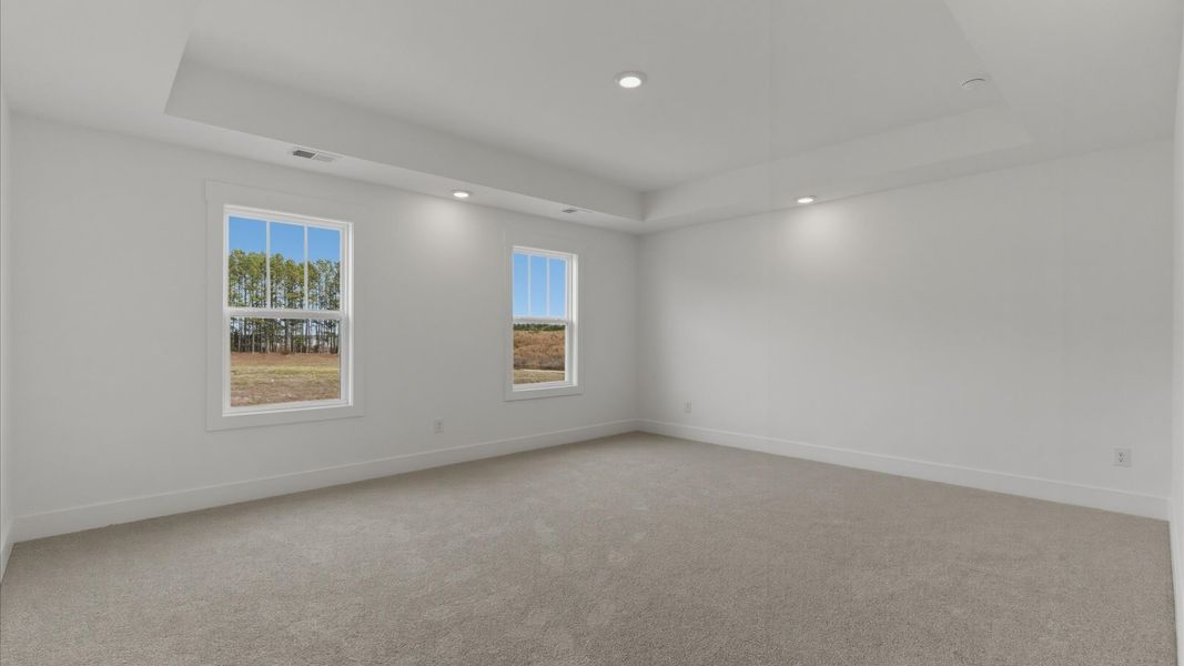 Accomplished design meets restful elegance in this exclusive primary suite with tray ceiling by DRB Homes