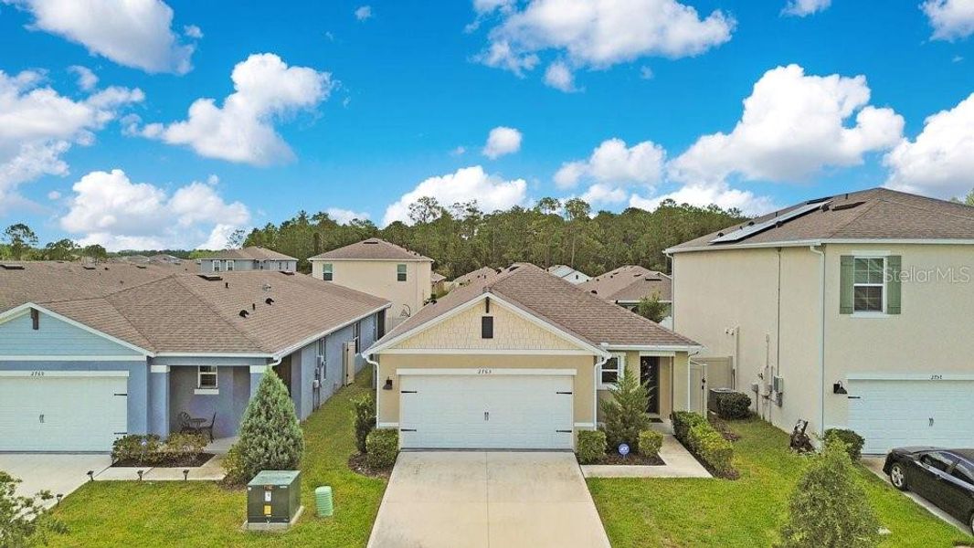 Front exterior of a new home in Harmony West, St. Cloud, FL, highlighting curb appeal (Image 23). Front exterior of a new home in Harmony West, St. Cloud, FL, highlighting curb appeal (Image 23).