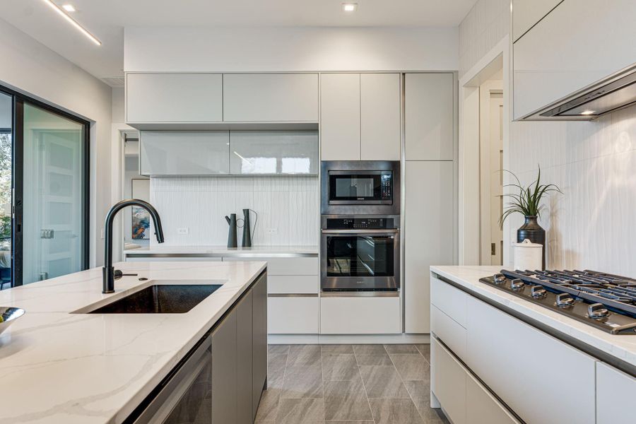 Designed for both style and performance, the chef’s kitchen features sleek European cabinetry, premium Samsung Bespoke appliances, and pristine Silestone countertops.