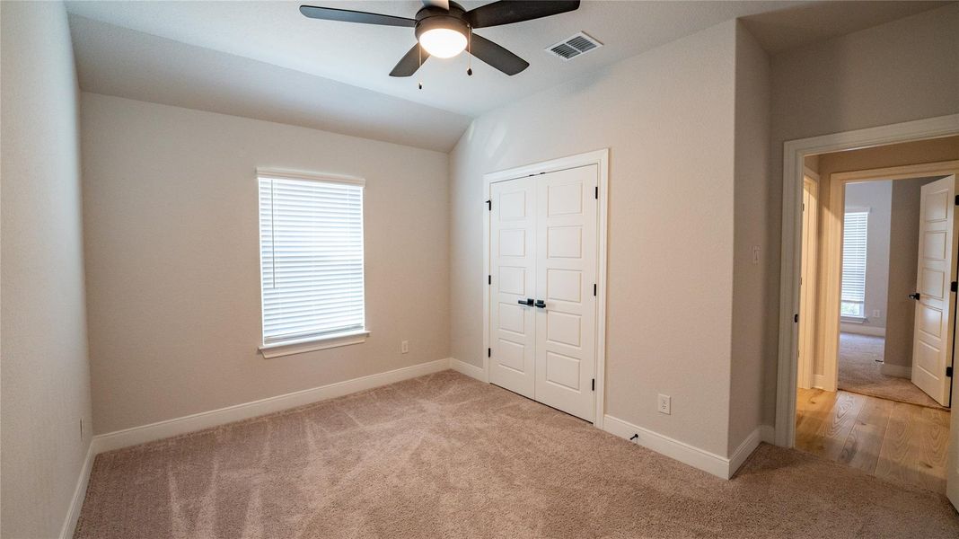 Unfurnished bedroom featuring light colored carpet, a closet, and ceiling fan Unfurnished bedroom featuring light colored carpet, a closet, and ceiling fan