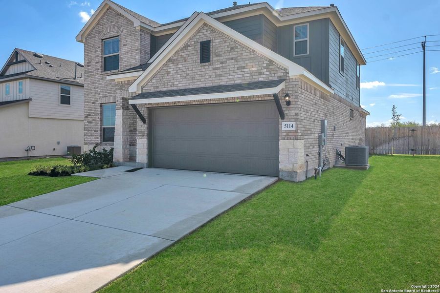 Front exterior of a new home in Morgan Meadows, San Antonio, TX, highlighting curb appeal (Image 2). Front exterior of a new home in Morgan Meadows, San Antonio, TX, highlighting curb appeal (Image 2).