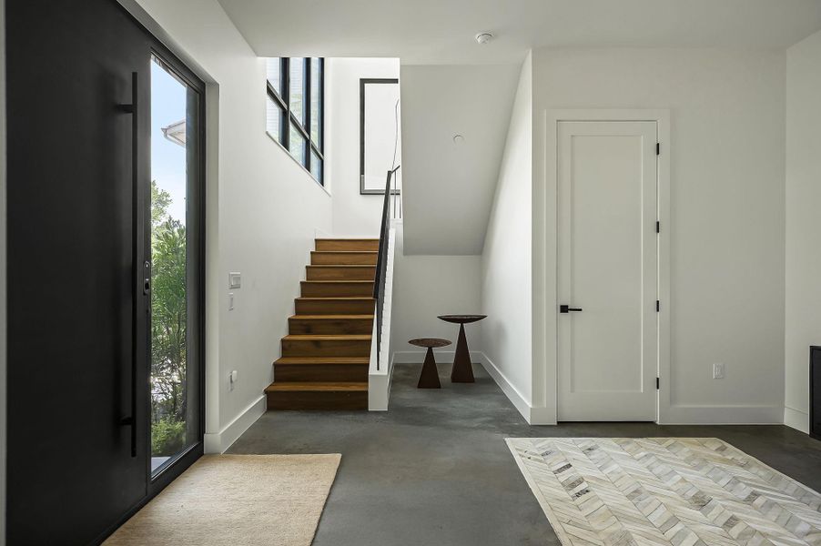 This gorgeous stairway with warm wood tones draws you upstairs to the main living room and heart of the home
