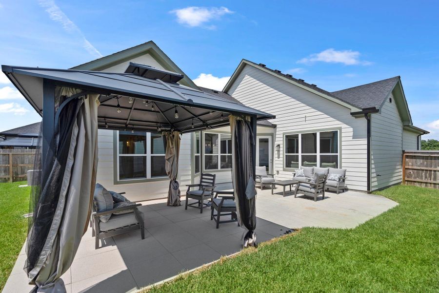 Step into the private Portico courtyard, an inviting outdoor space ideal for morning coffee, entertaining, or simply enjoying fresh air in your own backyard oasis. Image depicts home as-is.