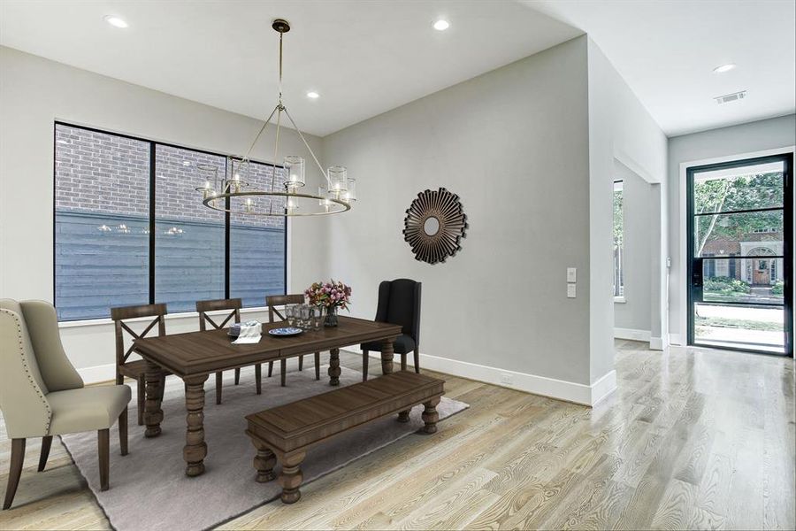 Elegant formal dining room with designer light fixture.  There is LED lighting throughout the home.