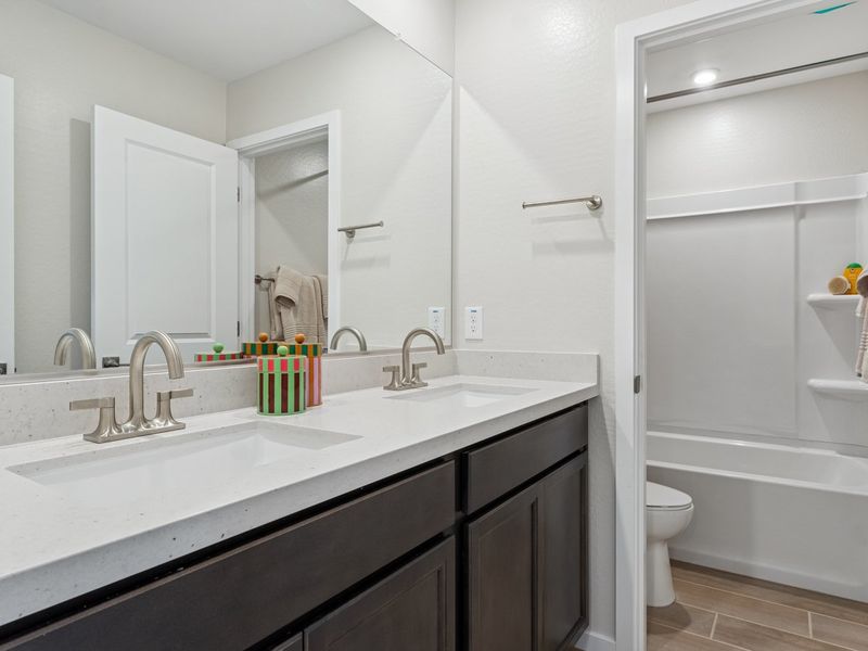 A bathroom with a tub sink and toilet. A bathroom with a tub sink and toilet.