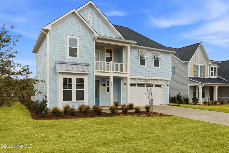 Front exterior of a new home in WyndWater, Hampstead, NC, highlighting curb appeal (Image 1). Front exterior of a new home in WyndWater, Hampstead, NC, highlighting curb appeal (Image 1).