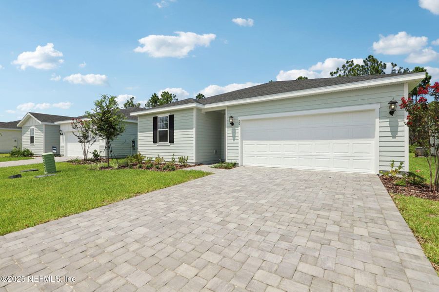 Front exterior of a new home in Colbert Landings, Palm Coast, FL, highlighting curb appeal (Image 15).