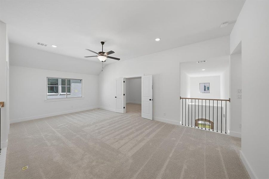 Spare room featuring vaulted ceiling, light colored carpet, recessed lighting, and ceiling fan Spare room featuring vaulted ceiling, light colored carpet, recessed lighting, and ceiling fan