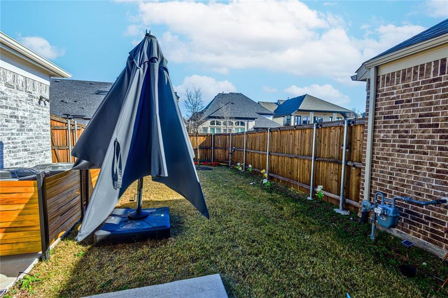 Fenced backyard featuring a residential view