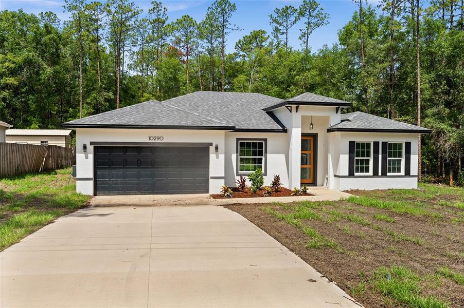 Front exterior of a new home in , Citrus Springs, FL, highlighting curb appeal (Image 1).