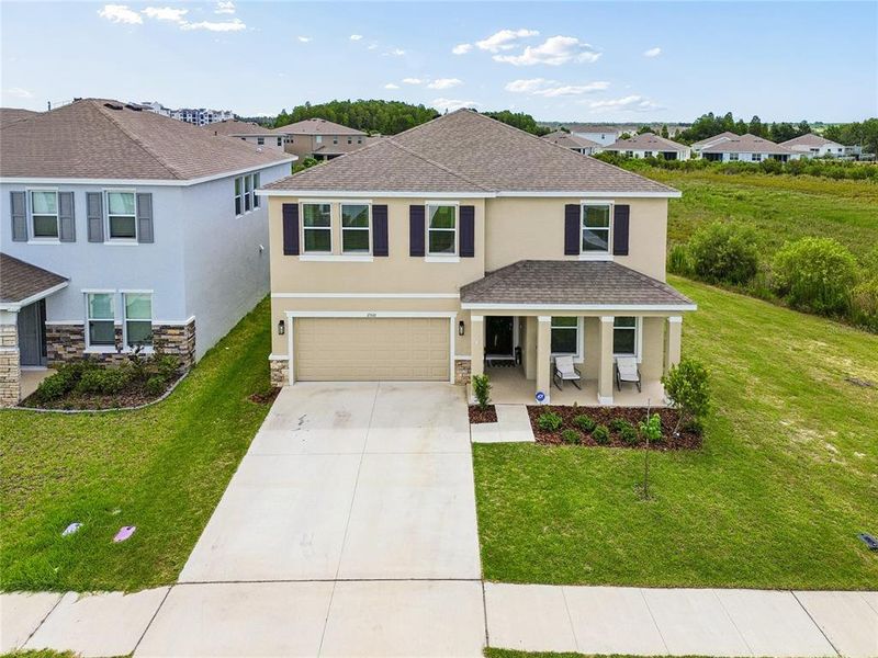Front exterior of a new home in Woodcreek, Wesley Chapel, FL, highlighting curb appeal (Image 2). Front exterior of a new home in Woodcreek, Wesley Chapel, FL, highlighting curb appeal (Image 2).