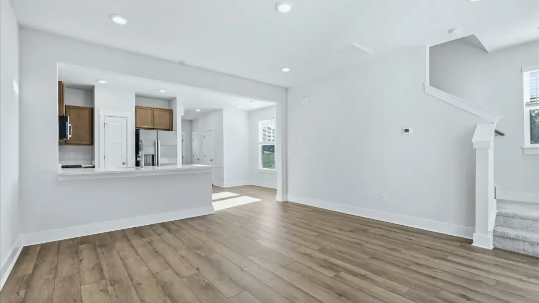First-rate family room with thoughtful layout and superior connection to kitchen and dining spaces at Clarke Townes