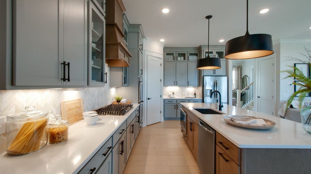 Kitchen with upgraded appliances, corner pantry, and modern floor-to-ceiling cabinets Kitchen with upgraded appliances, corner pantry, and modern floor-to-ceiling cabinets