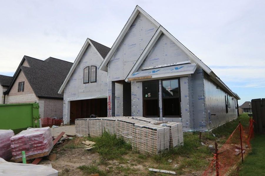 Front exterior of a new home in Riceland 50’ Front Load Homesites, Mont Belvieu, TX, highlighting curb appeal (Image 6).
