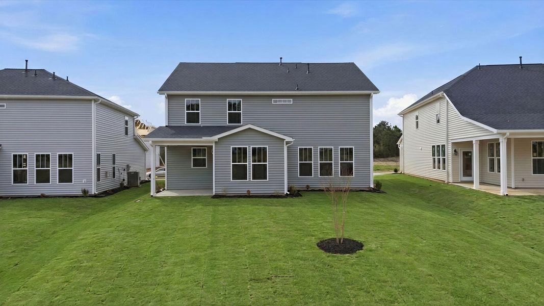 Exceptional outdoor living begins with a covered back porch in this thoughtfully designed home in Gray Court, SC