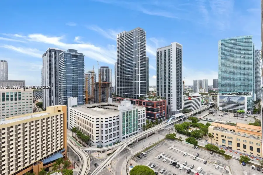 Elevated urban perspective featuring high-rise architecture, glass-facade skyscrapers, and metropolitan infrastructure Elevated urban perspective featuring high-rise architecture, glass-facade skyscrapers, and metropolitan infrastructure