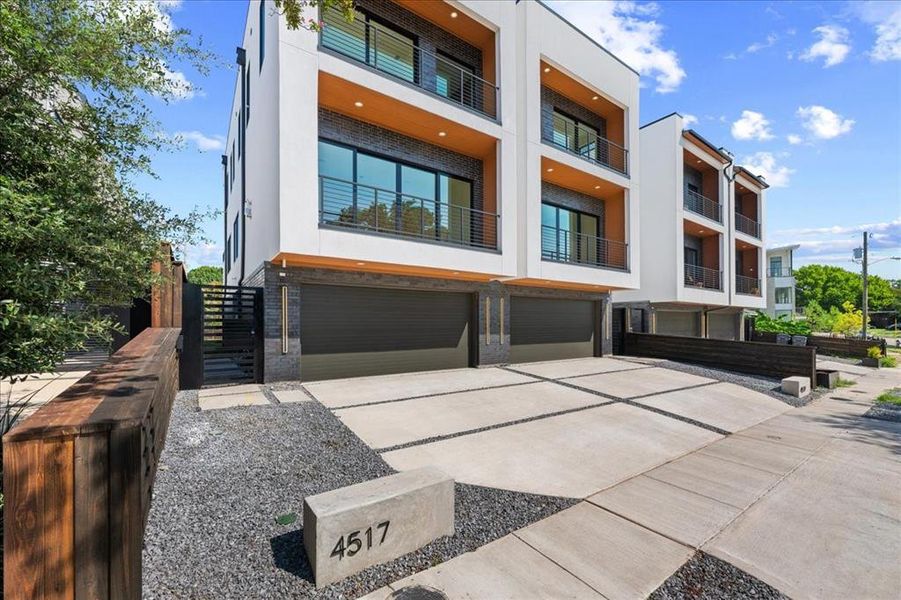 View of building exterior featuring an attached garage and concrete driveway View of building exterior featuring an attached garage and concrete driveway