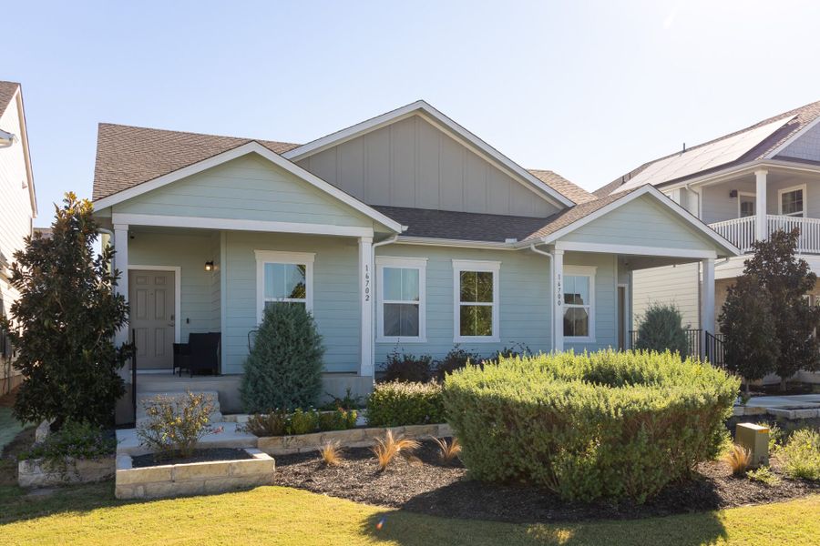 Front exterior of a new home in Whisper Valley, Manor, TX, highlighting curb appeal (Image 1). Front exterior of a new home in Whisper Valley, Manor, TX, highlighting curb appeal (Image 1).